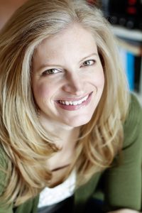 Amy Engel smiling blond woman in green sweater
