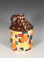 Stoneware jug glazed in colorful patterns.