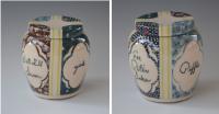 Stoneware jar with patterns and script.