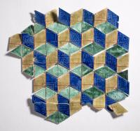 Stoneware tiles in blue, green and neutrals making cube shapes, wall display.