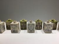 Stoneware vases covered in script and images.