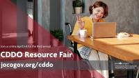 CDDO Resource Fair A woman waves to someone she is chatting with on her laptop