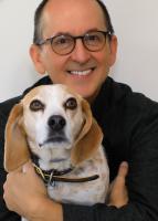Photograph of John Keeling holding a dog.