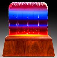 Resin sculpture with jagged edge and color fade of red, blue, purple and orange.