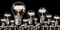 Lightbulbs with filaments showing words like training, knowledge, skills and development
