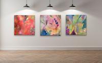 Three brightly colored abstract paintings hanging on a wall.