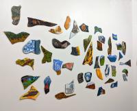 Wall installation of painted fragments.