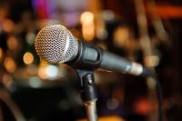 photo of a microphone in front of a blurred background