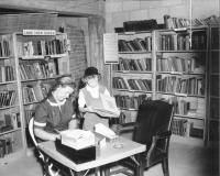 Mrs. Monte Redman and Judy Redman in Prairie Village Volunteer Library.