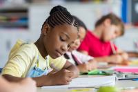 Young people writing at a table