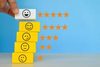 wooden blocks with a range of emojis with one to five stars