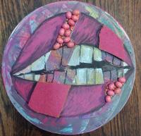 Mixed media painting of a mouth and teeth painted on a wood round.