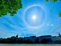 Photo of a circular rainbow around the sun.