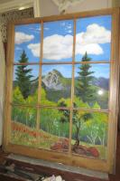 Landscape painting on a window pane frame.