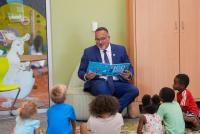 Secretary Cardona reads a book to a group of children at Central Resource Library
