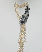 Photo of a sculptural necklace made from mixed materials.