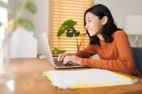 Woman typing on a laptop