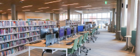 Inside Merriam Plaza Library - computers desks and stacks of books