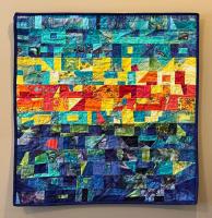 Multi-color quilt made from angular shapes.