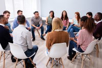 Photograph of a discussion group with members seated in a circle.