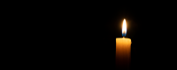 Photo of a single candle flame in darkness