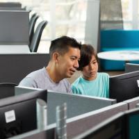 Two people sitting at a computer