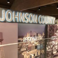 A backlit sign reading "Johnson County" in front of a display at the Johnson County Museum