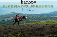 Cinematic photo scene of a woman and her donkey traversing foothils with mountains behind them and the text in the sky reading Kanopy cinematic journeys in July.