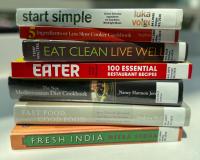 A stack of books focused on healthy eating and cooking healthy meals