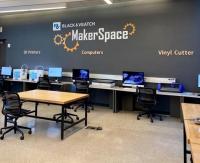MakerSpace photo with logo on the wall and computers. 