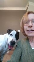 Marcia Hurlow and Lucky red haired woman in green sweater with a black and white dog