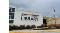 The front of Central Resource Library with a new Johnson County Library sign