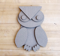 Image of cardboard shapes cut out to resemble a cartoon owl