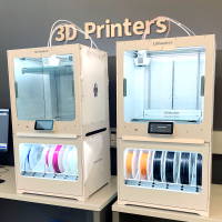 image of two 3D printers, both with color materials loaded underneath.