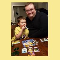 Librarian Charles and his child playing King of Tokyo