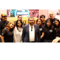 Erik Erazo (center, in a suit coat) and members of the Olathe Leadership Lowrider Bike Club at the Johnson County Museum before unveiling their contribution to the Museum’s collection, now on display. 