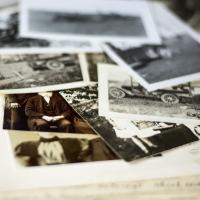 Old sepia and black and white photos in a pile