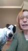 Marcia Hurlow and Lucky red haired woman in green sweater with a black and white dog