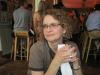 Vicki Kohl Curly-haired blond woman with glasses, hands folded in front of her, looking pensive